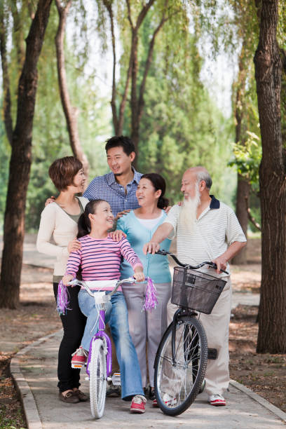 Chinese family with bicycles in park